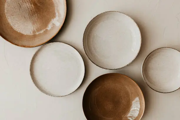 Flat lay, top view. Brown and natural color plates. Textured grainy pattern on the plates.