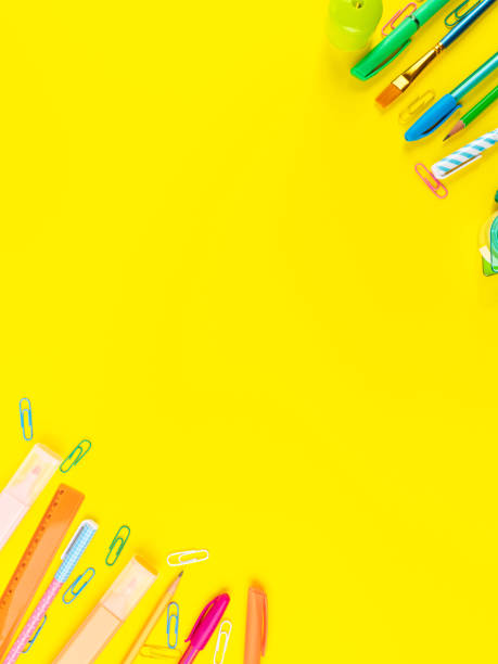 istock Back to school concept. Colorful writing tools frame on yellow background 1331026760