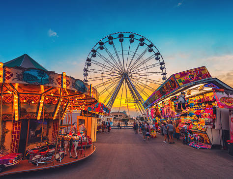 Varna, Bulgaria - July 16, 2020: Amusement park outdoor scene. Have fun with Ferris wheel and attraction swings situated in Sea port Varna city, Bulgaria.