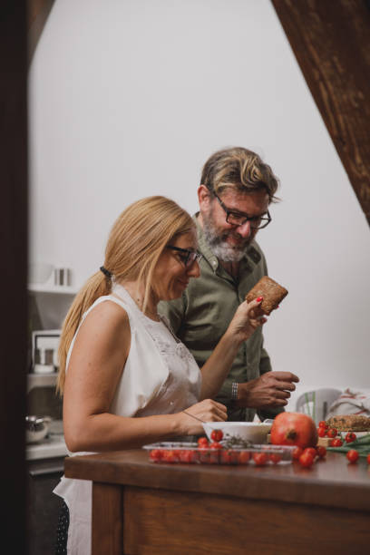 istock Married couple making sandwiches together 1331028795