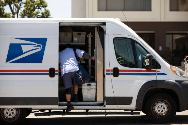 USPS Fullerton, California, USA - July 6, 2021: A USPS Postal worker delivers mail. united states postal service photos stock pictures, royalty-free photos & images