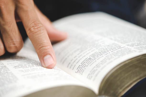 istock Close-up of man's hands while studying the Bible. 1331030637