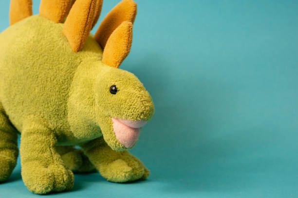 dinosaur doll isolated on blue background
