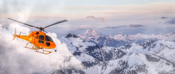 istock Yellow Helicopter flying over the Rocky Mountains 1331032693