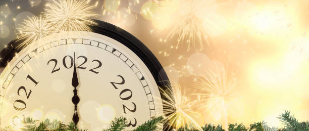 istock New Year 2022 clock and fireworks background. 1331034716