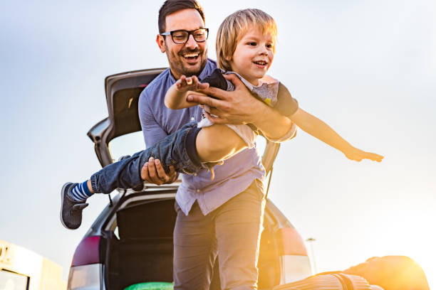 istock Playful single father having fun with his small boy on the street. 1331036204