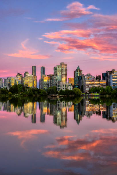 View of Lost Lagoon in famous Stanley Park in a modern city with buildings skyline View of Lost Lagoon in famous Stanley Park in a modern city with buildings skyline in background. Colorful Sunset Sky. Downtown Vancouver, British Columbia, Canada. vancouver canada stock pictures, royalty-free photos & images