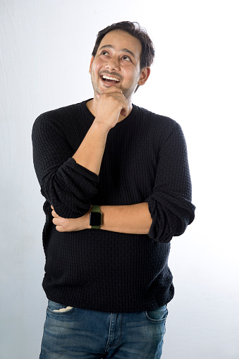 Young man thinking over white background