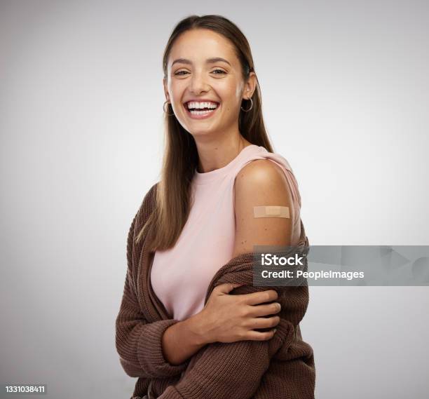 Shot Of A Young Woman Standing Alone In The Studio After Getting Vaccinated Stock Photo - Download Image Now