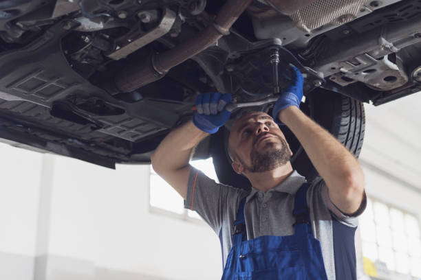 istock Professional mechanic working under a car 1331039288