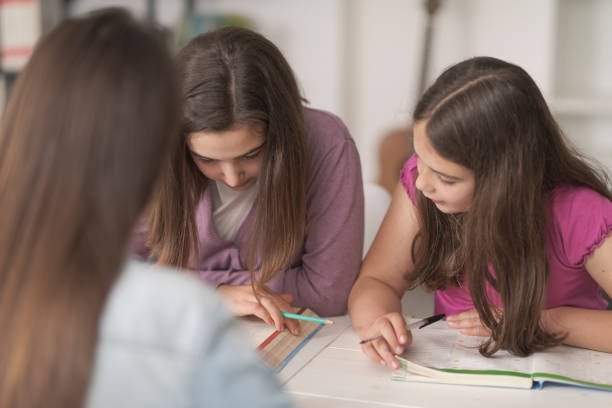 istock Young mother helping kids with their homework 1331039628