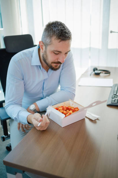 istock Businessman eating pasta for lunch 1331039724