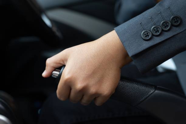 istock Formally dressed woman pulling on the handbrake while parking 1331041679