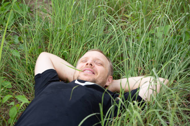 istock Caucasian hipster  lying on grass, relax, happyness concept 1331045360