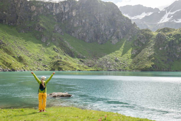 istock Young woman on mountain top arms outstretched 1331045702