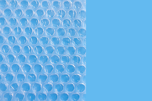 Bubble Wrap Packing Or Air Cushion Film on a blue background.