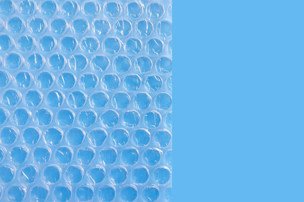 bubble wrap packing or air cushion film on a blue background. - foot wraps imagens e fotografias de stock