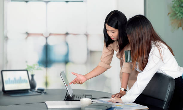 istock Two young asian female discussing about business plan in office. 1331048508