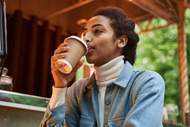 istock Woman drinking coffee and looking away while feeling rest and calm 1331049685