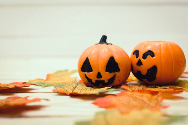 istock Halloween pumpkins with painted faces on a wooden table. Halloween background. Space for text. copy space. 1331050141