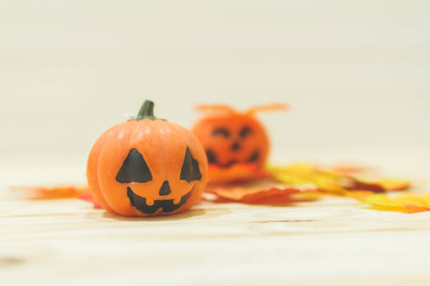 istock Halloween pumpkins with painted faces on a wooden table. Halloween background. Space for text. copy space. Halloween concept 1331050158