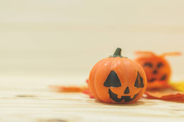 istock Halloween pumpkins with painted faces on a wooden table. Halloween background. Space for text. copy space. Halloween concept 1331050166