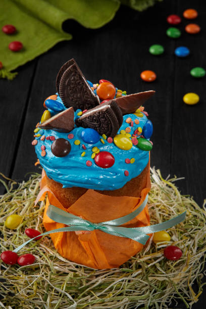 Easter cake with blue whipped egg whites icing and sweets
