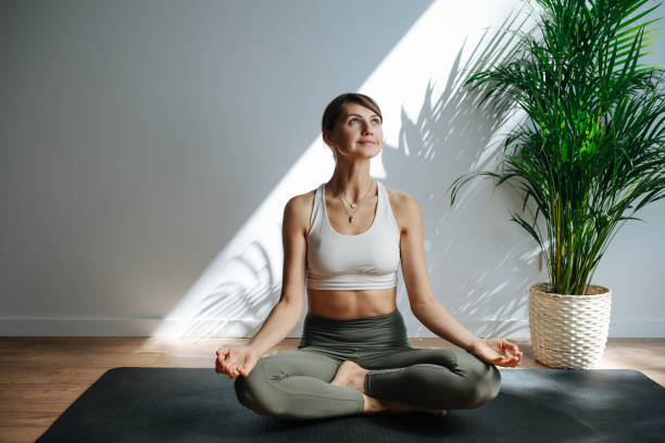 istock Joyful woman practicing yoga, meditating. Frontal view 1331054090