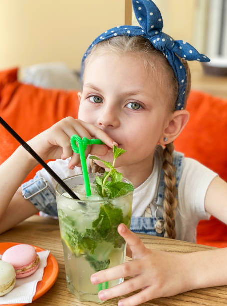 istock Little girl drinking non-alcoholic mojito 1331054381