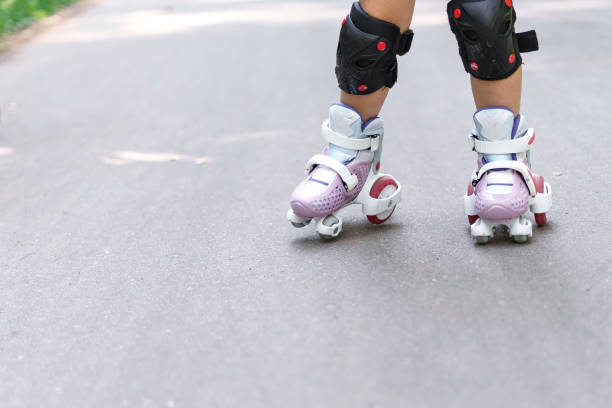 istock kid is rollerblading in the park. legs close up 1331056651