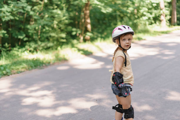 istock cute kid girl learning to roller skate 1331056656