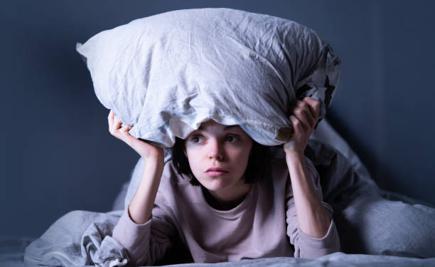 istock Woman covered with a blanket and is worried about insomnia, getting stress. 1331056800
