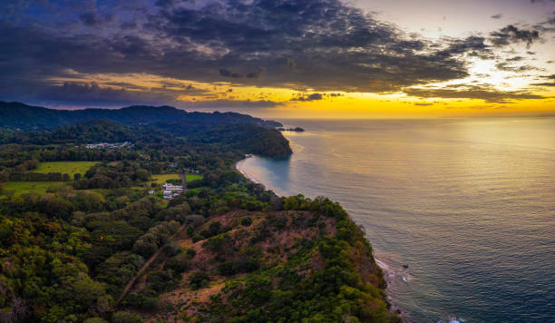 Sunset above coastal forest of Costa Rica Aerial view of a sunset above coastal forest of Costa Rica costa rican sunset stock pictures, royalty-free photos & images