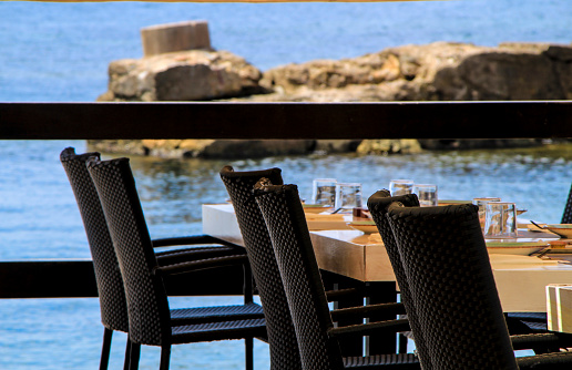 Bar with empty terrace on Cabo de Palos beach, Cartagena province, on a sunny day