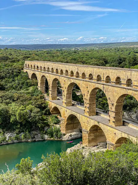 Roman aqueduct seen through foliage, Pont-du-Gard, Languedoc-Roussillon France