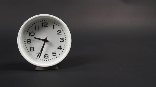 istock the Alarm clock with hour hand and second hand on black background. 1331062693