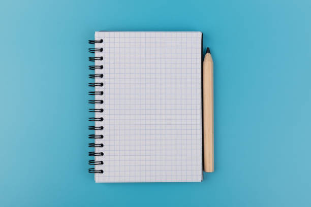 istock Blank paper and pencil on a blue background 1331062698