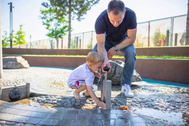 istock Child playing with a toy car while his father helping him 1331062744