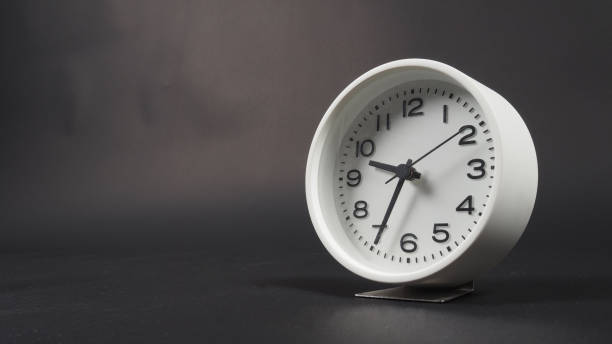 istock the Alarm clock with hour hand and second hand on black background. 1331062775