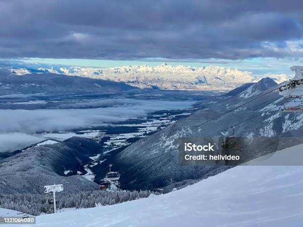 Scenic View Of An Operating Skilift Moving Up A Slope Overlooking Wintry Valley Stock Photo - Download Image Now