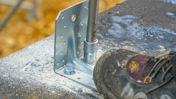 istock CLOSE UP: Builder uses a power drill to fasten a bolt into concrete foundations. 1331064199
