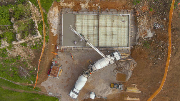 istock TOP DOWN: Workers pouring concrete from a truck, creating the house foundation. 1331064853