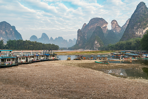 Boats on Li River at sunrise. Yangshuo. Guangxi Province.