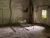abandoned bedroom in a ruined house after a natural disaster