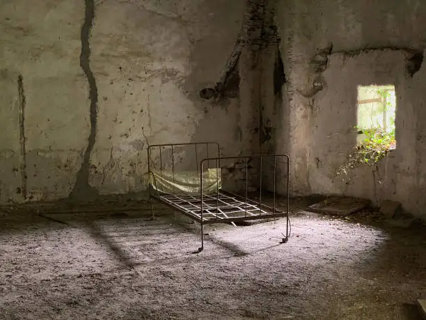 Photo of abandoned bedroom in a ruined house after a natural disaster