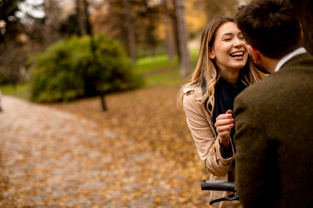 istock Young couple in the autumn park with electrical bicycle 1331065793