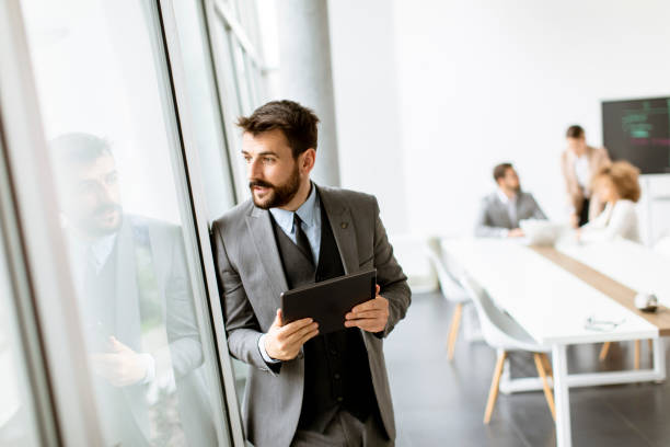 istock Young modern businessman using digital tablet in the office 1331065901