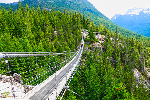 Squamish, BC, Canada - June 24, 2019: Sky Pilot Suspension Bridge, Walk on the suspension bridge and enjoy the wide view. It goes both up to the mountains above and down to Howe Sound below.