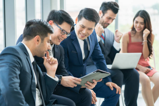 istock group of business people brainstorming while having workshop training at seminar hall, Business speaker advising business planning, Business workshop training event. Business workshop training concepts. 1331068303