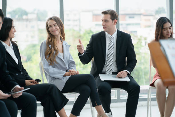 istock group of business people exchanging idea while having workshop training at seminar hall, Business speaker advising business planning, Business workshop training event. Business workshop training concepts. 1331068405